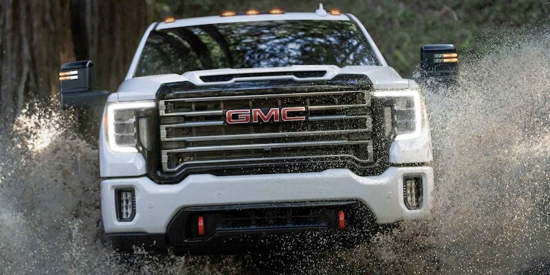 White Sierra driving through water